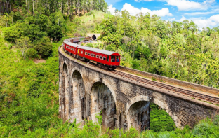 red train on a bridge